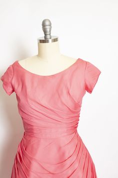 "Gorgeous vintage late 50s - early 60s party dress. Medium pink chiffon is beautifully pleated from the side seams of skirt, around rounded seam at seat and from side waist. Darted bust cap sleeve top with wide scoop neck. Hidden back metal zipper. Skirt is backed with a still inset to add volume in a bell shape - bodice lined in cotton. Label: Erlenbaches DC Fits like size: Extra Small - See measurements to be sure. Measurements: Bust: 34\" Waist: 23.5-firm 24\" Hip: free Length: 37 Condition: Pink Fitted Dress With Box Pleat, Vintage Fitted Dress With Ruched Bodice, Fitted Vintage Dress With Ruched Bodice, Pink Party Dress With Fitted Waist, Vintage Pink Dress With Fitted Bodice For Party, Pink Vintage Dress With Fitted Bodice For Party, Vintage Party Dresses With Pleated Waist, Vintage Ruched Dress With Fitted Bodice, Vintage Ruched Dress For Garden Party