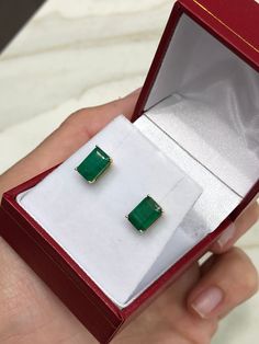 Featured here is a beautiful set of emerald cut Colombian emerald studs in fine 14K yellow gold. Displayed are medium-green emeralds with very good transparency, accented by a simple four-prong 14K gold mount, allowing for the emerald to be shown in full view. The earth mined, Brazilian emeralds have a desirable lush green color with excellent qualities. These earrings are ideal for everyday use and are the perfect accessory to any outfit. Total Carat Weight: 2.52cts Setting Style: Four Prong Se Green Baguette Cut Earrings For Gifts, Baguette Cut Emerald Earrings As A Gift, Emerald Cut Green Gemstone Earrings, Emerald Cut Green Earrings, Rectangular Emerald Earrings Fine Jewelry, Fine Jewelry Emerald Rectangular Earrings, Emerald Rectangular Earrings For May Birthstone, Rectangular Emerald Gemstone Earrings, Emerald Cut Emerald Earrings In Yellow Gold