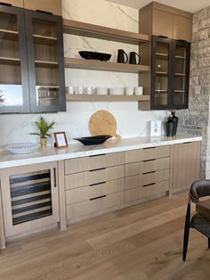 a kitchen with wooden cabinets and marble counter tops