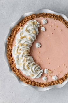 a pie topped with whipped cream on top of a white plate