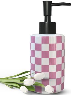 a pink and white soap dispenser with tulips on the side