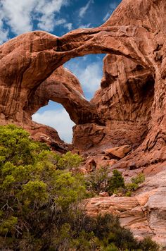 an arch shaped rock formation in the desert