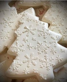 some white cookies with snowflakes on them