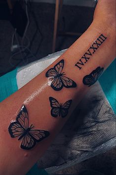 a woman's arm with three butterflies on it and the word mama written in black ink