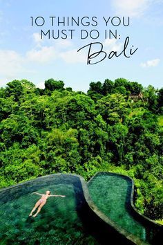 a person swimming in a pool surrounded by lush green hills and trees with the words 10 things you must do in bali