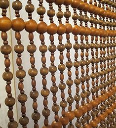 wooden beads are hanging on the wall