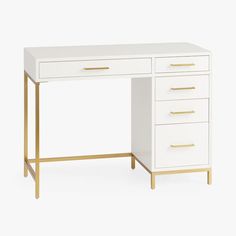 a white desk with gold handles and drawers on it, against a white background that is also part of the furniture collection