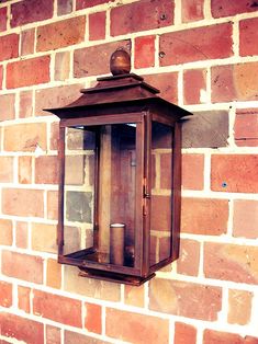 a brick wall with a lantern on it