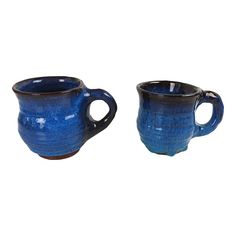 two blue mugs sitting next to each other