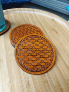 two wooden coasters sitting on top of a table