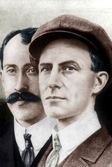 two men with mustaches and hats are standing side by side in front of an old photo