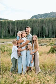 a family posing for a photo in a field