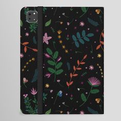 an iphone case with flowers and leaves on black leather, the cover is open to show it