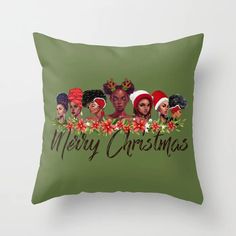 a green pillow with the words merry christmas and five black women wearing red headscarves