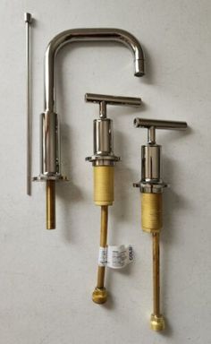 two brass faucets and one silver faucet