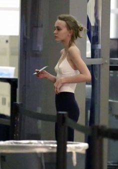 a woman in tights is walking through an airport