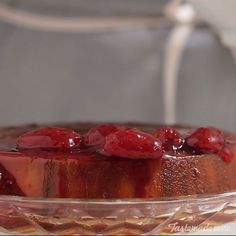 a dessert with raspberries on top in a glass bowl