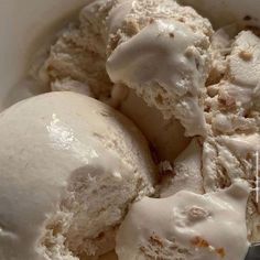 two scoops of ice cream in a white bowl