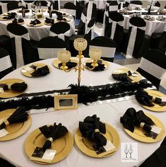 black and white tables with gold plates and place settings for dinner or wedding guests to eat