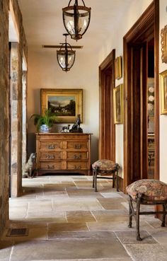 the hallway is lined with antique furniture and paintings