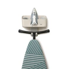 an ironing board with a tie hanging from it's hook on the wall