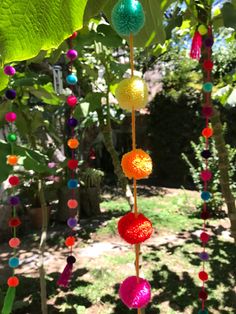 colorful beads hanging from the branches of a tree