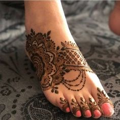 the feet are decorated with henna designs