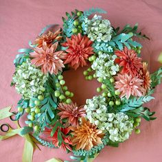 a wreath made out of flowers and greenery with the words frosted paper summer wreath