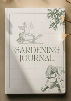 the book gardening journal is sitting on top of a table