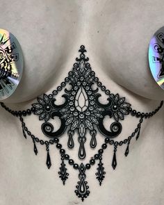 an image of a woman's chest with black lace on it and two circular discs attached