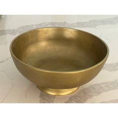 a gold bowl sitting on top of a table