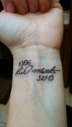 a person with a wrist tattoo that has the date 1950 and is written on it