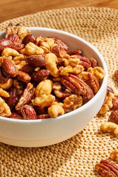 a white bowl filled with nuts on top of a table