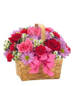 a basket filled with red and pink flowers