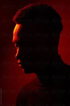 the silhouette of a woman's head against a red background