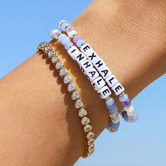 In honor of Mental Health Month, we’ve created a daily reminder to help you breathe, heal, and grow. All it takes is a moment to reset as you look down at your wrist: breathe in the good vibes, exhale the negativity. This two-set bracelet pack is handcrafted with crystal, mother of pearl, and faceted glass rondelle beads. Set Kindness in MotionThe cycle of kindness starts with you. It’s why each of our bracelets has a trackable ID tag, so you can one day pass it on and pay its meaning forward. C Wednesday Bracelet, Mental Health Bracelets Diy, Health Bracelet, Affirmation Bracelets, Initial Birthstone Necklace, Blessing Bracelet, Bracelet Pack, Awareness Bracelet, Kendra Scott Earrings