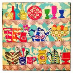 an image of colorful teapots and cups on the shelf in this quilted wall hanging