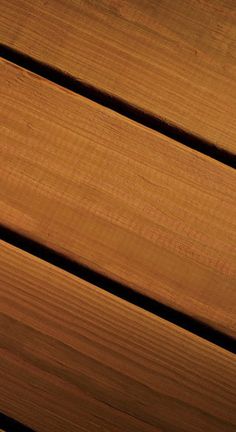 a cell phone sitting on top of a wooden table