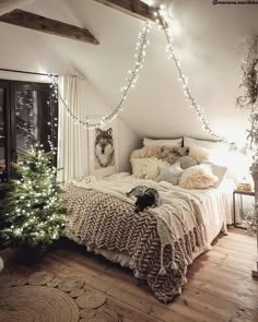 a bedroom decorated for christmas with lights strung from the ceiling and a dog on the bed