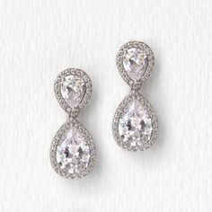 The sparkle and timeless shape of these pear drop earrings will have you feeling like a classic beauty at your next special occasion. Medium weight with good movement, these drops are the perfect earrings to wear with an elaborate headpiece accessory or dress. 18K White Gold over base metal Cubic Zirconia pave crystals Hypoallergenic post Height 0.9in(2.2cm) x Width 0.4in(1cm) Available in post earrings or clip-ons #E340 Drop Diamond Earrings, Teardrop Earrings Wedding, Wedding Rings Teardrop, Headpiece Accessories, Sterling Silver Name Necklace, Jewelry Bridal, Drop Dangle Earrings, Bridal Gold Jewellery, Diamond Drops