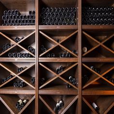 a wooden wine rack filled with lots of bottles