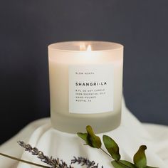 a white candle sitting on top of a table