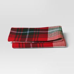 two red and green plaid napkins sitting on top of each other