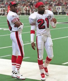 two football players are standing on the field