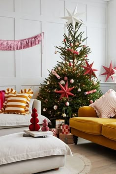 a living room with a christmas tree in the corner