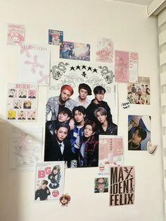 the wall is covered with many pictures and magnets, including one of them has been pinned to it