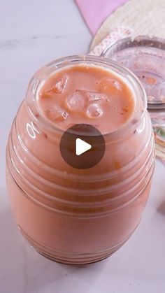 a glass jar filled with liquid sitting on top of a table next to other items