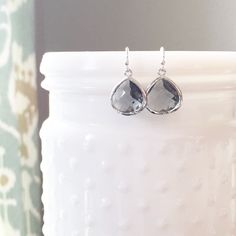 "DESCRIPTION: The MOLLY Earrings - Dainty Charcoal Gray faceted glass teardrop earrings. These pretty little earrings would make beautiful bridesmaid earrings yet are simple enough to add to your minimalist everyday earring collection! MATERIALS: Ear wires - Sterling Silver Teardrop - faceted glass set in rhodium plated SIZE: Approximately 1/2\" in length INCLUDED: All earrings come with plastic earring backers and care instructions. PACKAGING: Your earrings will arrive on a Dainty Doe signature Bridesmaid Earrings Silver, Grey Earrings, Silver Jewelry Cleaner, Bridesmaid Earrings Gold, Gray Earrings, Bridal Earrings Drop, White Jewelry Box, Plastic Earrings, Earring Collection