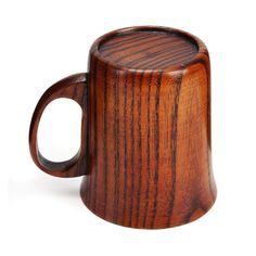 a wooden coffee mug sitting on top of a white table