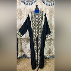 Brand New, Super Cute Modest Dress Great For Eid Al-Fita & Eid Al-Adha 2 Piece Black And Gold Modest Dress Dress Size 30” Across And 53” Long Woman Size 3xl Heavy Silky Fabric With Gold Design Embroidery (2 In Stock) Or Best Offer Will Be Shipped In A Sturdy Poly Mailer. Fitted Black Abaya For Eid, Fitted Long Abaya With Dabka Details, Fitted Long Abaya With Dabka, Fitted Black Embroidered Kaftan, Fitted Embroidered Black Kaftan, Fitted Long Thobe For Eid, Fitted Traditional Black Abaya, Fitted Embroidered Black Abaya, Black Long Dress With Dabka Detailing